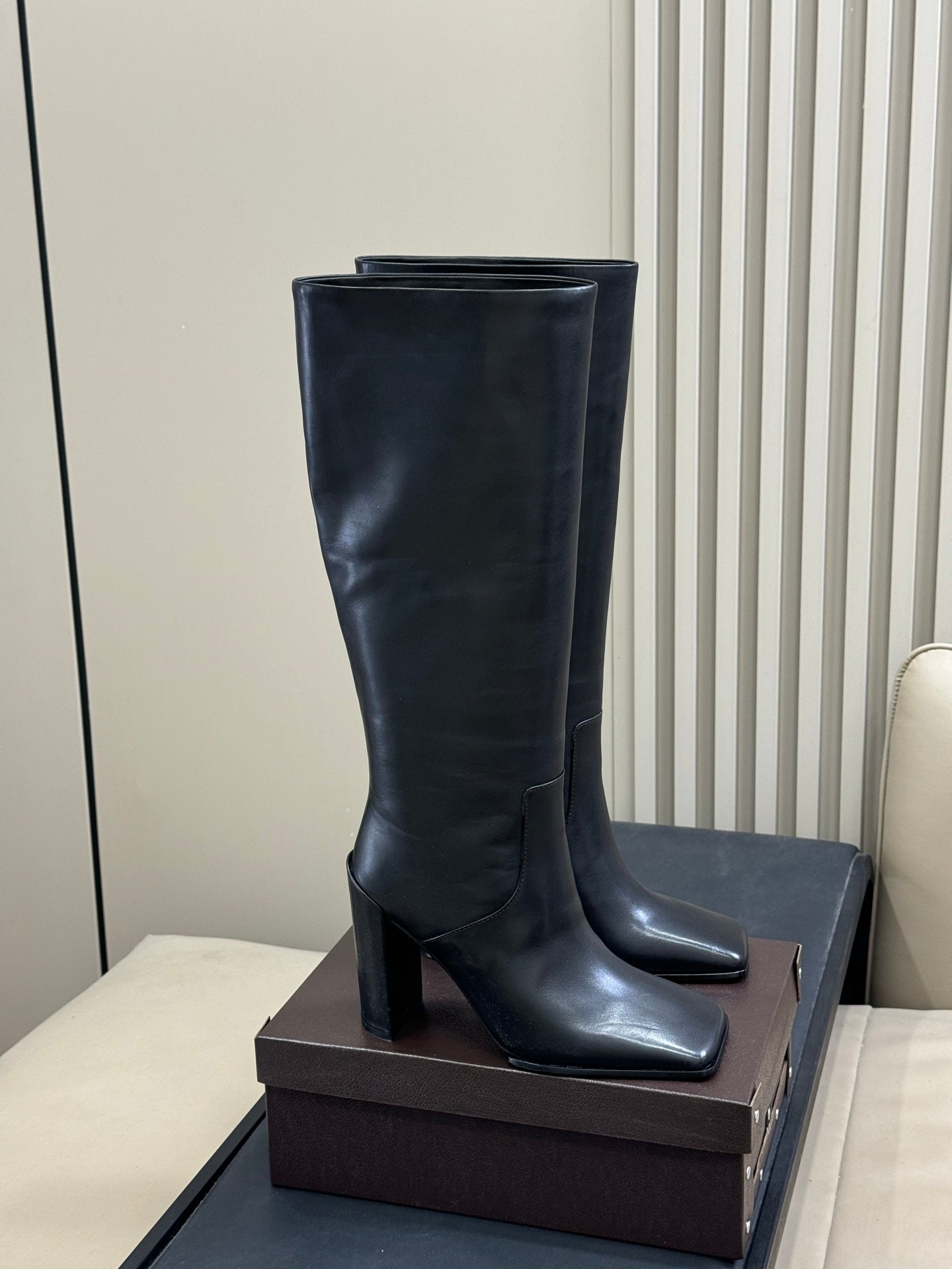 ALAIA 25S KNEE-HIGH SQUARE-TOE BOOTS IN BLACK CALFSKIN